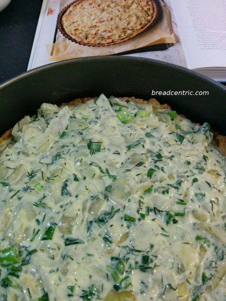 Onion tart with filling before baking